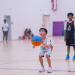 Young Harbor Sports Academy player dribbling the ball during a match
