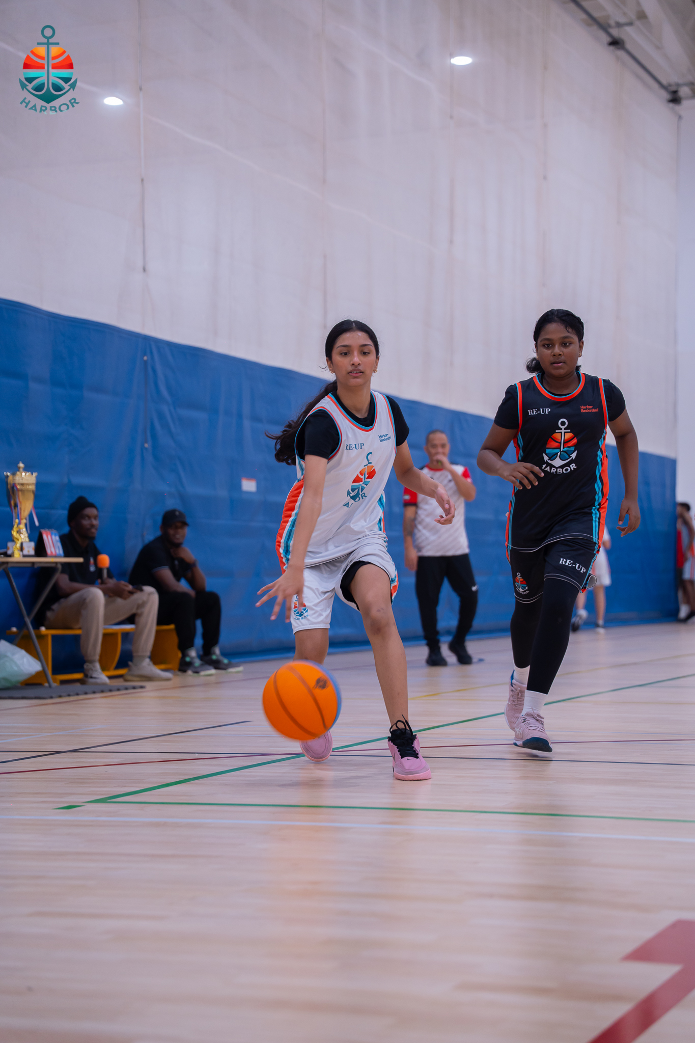 Young girl basketball player driving the ball on a fast break at Harbor Sports Academy