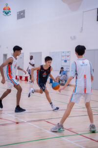 Harbor Sports Academy basketball players competing for the ball during a match