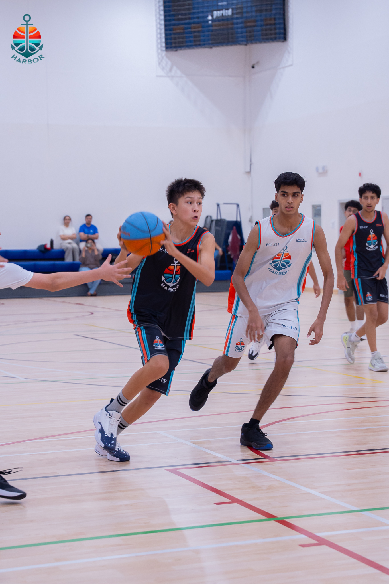 Harbor Sports Academy player driving to the basket past a defender