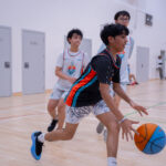 Harbor Sports Academy player driving the ball with teammates trailing the play