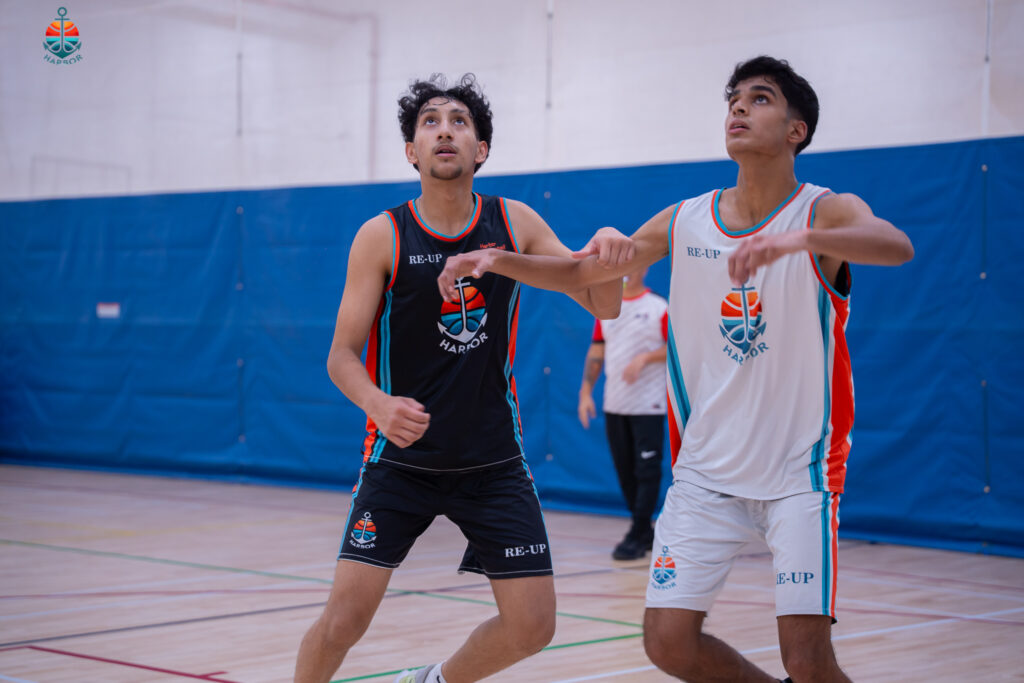 Harbor Sports Academy players contesting the ball during a tournament match