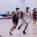 Harbor Sports Academy player driving to the basket past a defender