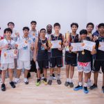 Harbor Sports Academy basketball squad celebrating their tournament trophy and medals